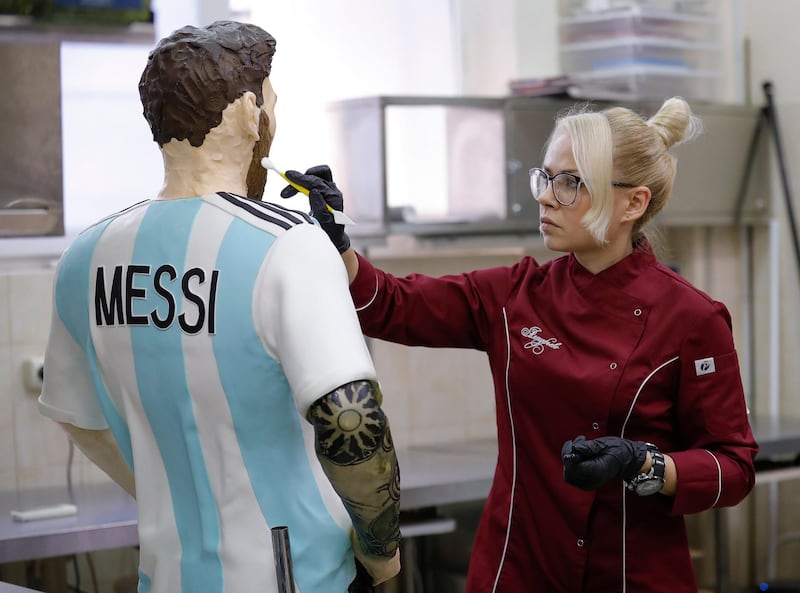 An employee of Altufyevo Confectionery finishes the preparation of a life-size chocolate sculpture of Lionel Messi. Reuters