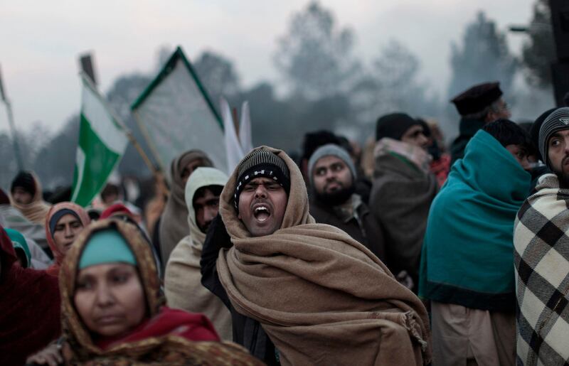 Supporters of Pakistani Sunni Muslim cleric Tahir-ul-Qadri, chant anti-government slogans during a rally in Islamabad, Pakistan, Tuesday, Jan. 15, 2013. Thousands of anti-government protesters are rallying in the streets of the Pakistani capital for a second day despite early-morning clashes with police who fired off shots and tear gas to disperse the crowd. (AP Photo/Muhammed Muheisen) *** Local Caption ***  APTOPIX Pakistan.JPEG-00b02.jpg