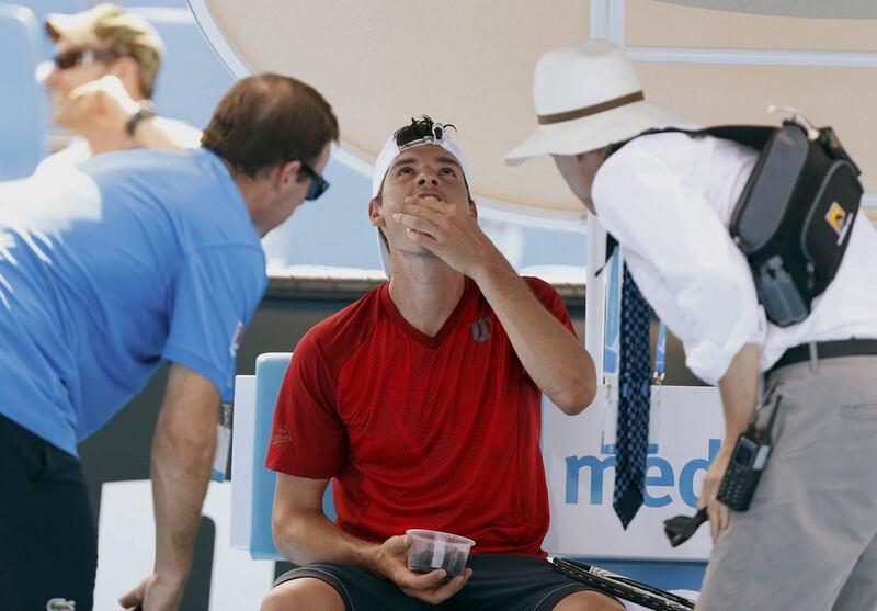Frank Dancevic of Canada receives medical attention during his men's singles match against Benoit Paire of France. Brandon Malone / Reuters