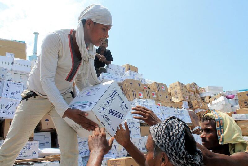 Yemeni workers unload medical aid boxes from a boat carrying 460 tonnes of aid from the UAE that docked in Aden on May 24, 2015. It was the second consignment of UAE aid to reach the city after 1,200 tonnes delivered the previous week. Saleh Al Obeidi / AFP