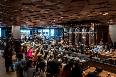 Visitors wait for their coffee at the Starbucks Reserve Roastery outlet in Shanghai on December 6, 2017.
Starbucks opened its largest cafe in the world in Shanghai on December 6 as the US-based beverage giant bets big on the burgeoning coffee culture of a country traditionally known for tea-drinking. / AFP PHOTO / - / China OUT