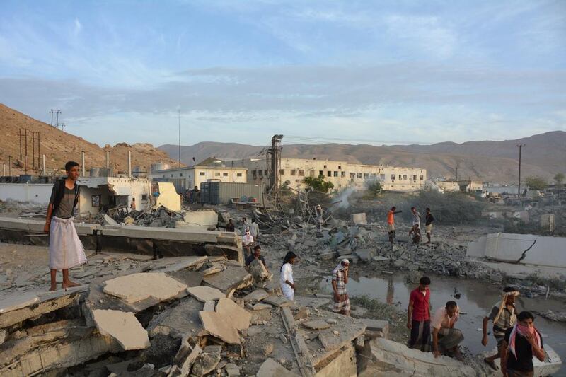 People inspect damage from Saudi-led air strikes on Mukalla port in southern Yemen on April 24, 2016. Reuters