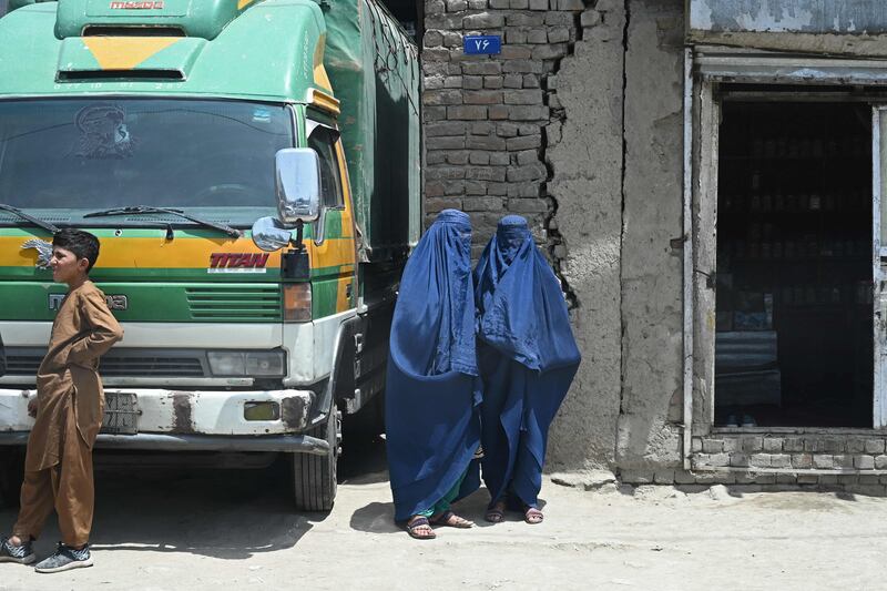 Afghan women and a boy outside a shop in the old quarter of Kabul.