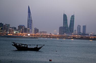 A boat sails past Bahrain's financial district in Manama. Private employers in Bahrain can begin hiring foreign workers again in August after a four-month suspension due to the coronavirus outbreak. Reuters