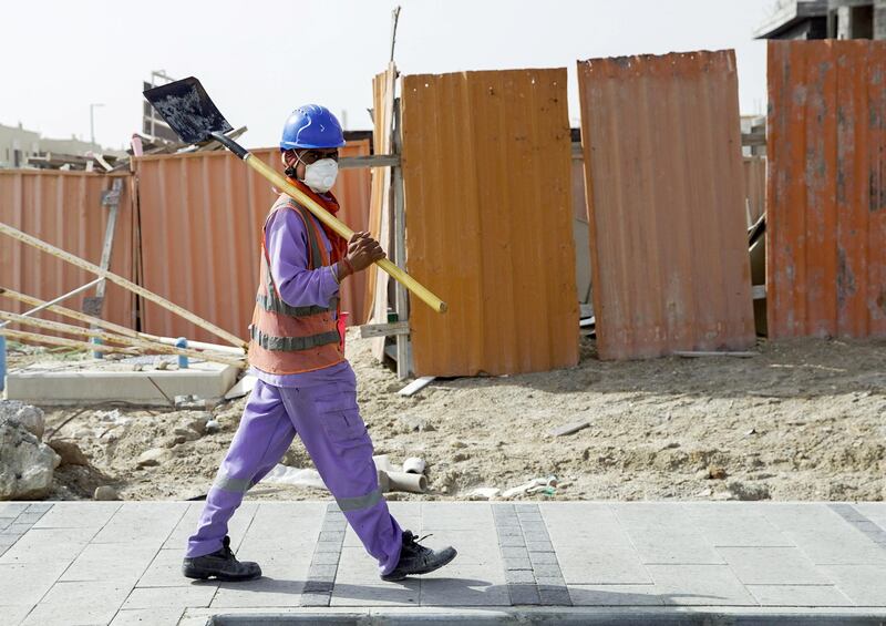 Abu Dhabi, United Arab Emirates, April 5, 2020.  A construction worker crosses the street with a mask on at Khalifa City, Abu Dhabi.  Face masks should be worn at all times when outside the home, the UAE government said on Saturday.              Victor Besa / The National
Section:  NA
Reporter: