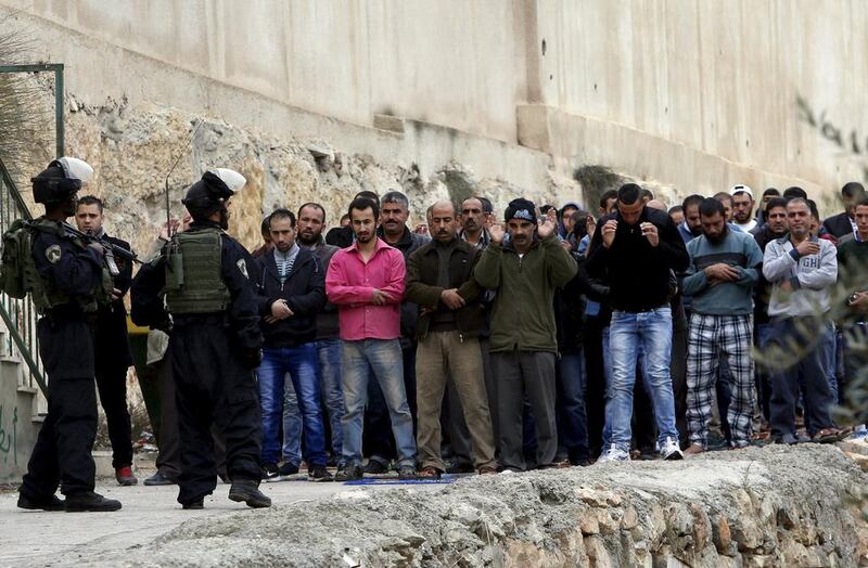 Israeli border police stand guard during Friday prayer outside a mosque in the West Bank city of Hebron on November 6, 2015. Elsewhere in the city, Israeli police shot dead a 73-year-old woman. Mussa Qawasma/Reuters