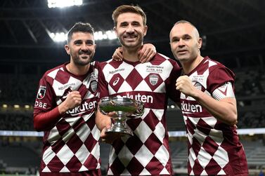 Vissel Kobe players Sergi Samper, centre, David Villa, left, and Andres Iniesta, right, pose with the Emperor's Cup. Getty Images