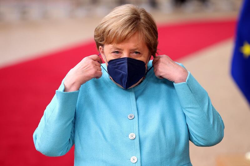 Angela Merkel, Germany’s chancellor, adjusts her protective face mask as she arrives at a European Union (EU) leaders meeting in Brussels, Belgium, on Thursday, June 24, 2021. German Chancellor Angela Merkel called on the European Union to coordinate rules for travelers from areas with outbreaks of Covid-19 variants as the risk of a renewed spike in infections remains. Photographer: Dursun Aydemir/Anadolu/Bloomberg