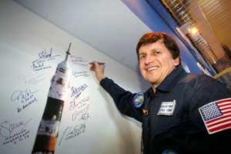 U.S. entrepreneur Charles Simonyi signs a poster at Baikonur cosmodrome in Kazakhstan March 20, 2009. Simonyi, Russian cosmonaut Gennady Padalka and U.S. astronaut Michael Barratt are scheduled to fly to the International Space Station on March 26, 2009. REUTERS/Sergei Remezov (RUSSIA POLITICS SCI TECH BUSINESS) *** Local Caption ***  BAI01_KAZAKHSTAN-_0320_11.JPG