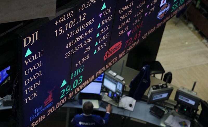 An electronic board displays trading activity and the Dow Jones Industrial Average. Jin Lee / Bloomberg