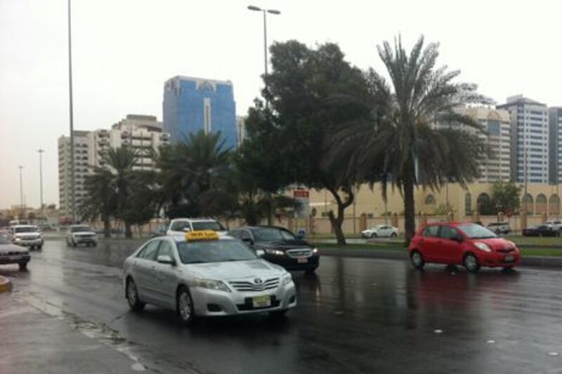 Motorists drive through the rain in Abu Dhabi. Forecasters say there is more to come. The National staff