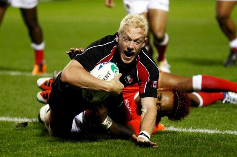 Canada's Phil Mackenzie scores a try during their Rugby World Cup Pool A match against Tonga at Northland Events Centre in Whangarei September 14, 2011.   REUTERS/Jacky Naegelen (NEW ZEALAND  - Tags: SPORT RUGBY IMAGE OF THE DAY TOP PICTURE)  