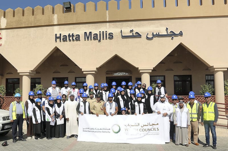 Fifty volunteers took part, visiting houses to clean the solar panels installed as part of Dewa’s project which installed solar panels on the roofs of villas in Hatta.  Courtesy: Dubai Media Office