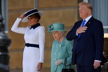 Britain's Queen Elizabeth II (C) stands with US President Donald Trump (R) and US First Lady Melania Trump (L) as they listen to the US national anthem during a welcome ceremony at Buckingham Palace in central London on June 3, 2019, on the first day of the US president and First Lady's three-day State Visit to the UK. Britain rolled out the red carpet for US President Donald Trump on June 3 as he arrived in Britain for a state visit already overshadowed by his outspoken remarks on Brexit. / AFP / POOL / TOBY MELVILLE