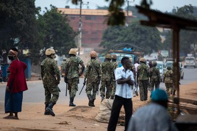 KAMPALA, UGANDA - JANUARY 14: Ugandan troops patrol the streets on January 14, 2021 in Kampala, Uganda. Observers fear violence as security forces try to stop supporters of opposition challenger Bobi Wine from monitoring polling places. Authoritarian President Yoweri Museveni is seeking a sixth term against the strong challenge from Wine, formerly a popular singer.  (Photo by Luke Dray/Getty Images)