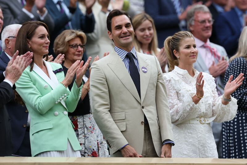 Roger Federer, centre, with his wife Mirka, right, and Kate, Princess of Wales, left, at the All England Club in Wimbledon. AFP