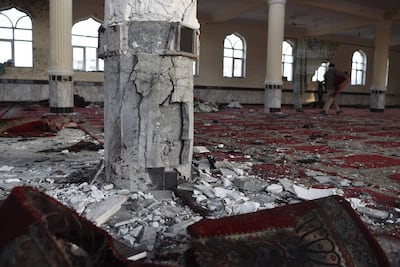 An Afghan man walks inside the Imam Zaman Shiite mosque the day after a suicide attack during evening prayers, in Kabul on October 21, 2017.
A strong smell of blood and flesh permeated the Imam Zaman mosque in Kabul on October 21 hours after dozens of Shiite worshippers were slaughtered by a suicide bomber during evening prayers. Broken glass and dust covered the red carpet, soaked in the blood of the men, women and children who had been praying on Friday when the attacker blew himself up, causing carnage in the cavernous prayer hall.
 / AFP PHOTO / WAKIL KOHSAR