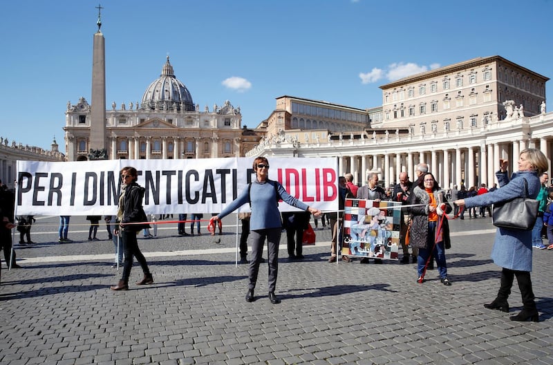 People protest against war in Syria, keeping one metre distance at the St. Peter's Square where Pope Francis will deliver the weekly Angelus prayer via video. Reuters