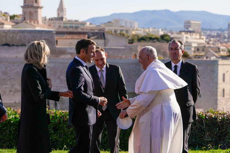 Pope Francis being welcomed by President Macron and his wife Brigitte as he arrives for the final session of the Rencontres Mediterraneennes meeting at the Palais du Pharo. AP