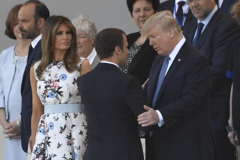 French president Emmanuel Macron greets the Trumps.Saul Loeb  / AFP Photo