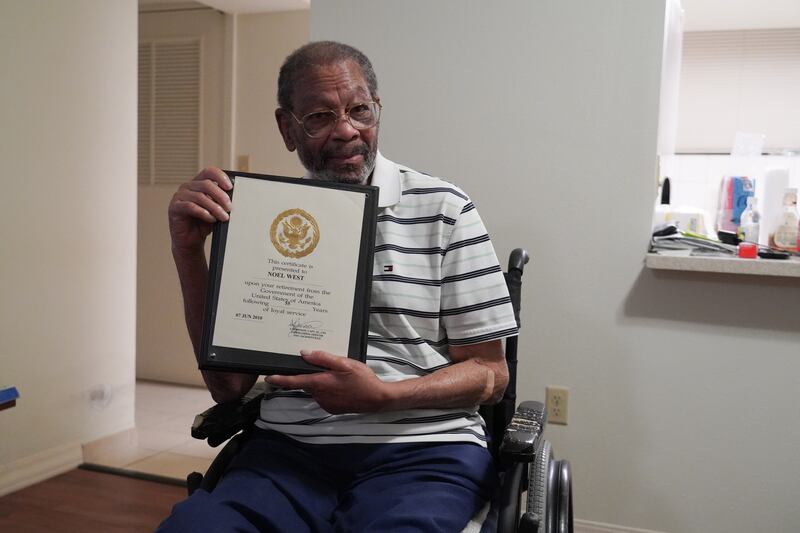 Noel West, 88, holds a plaque  commemorating his 55 years of service to the US naval station in Guantanamo Bay. Willy Lowry / The National