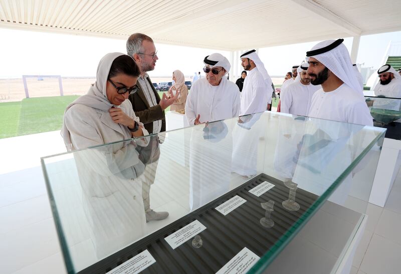 Sheikh Majid bin Saud Al Mualla and Noura Al Kaabi, Minister of Culture and Youth, are shown artefacts that were discovered at the site.