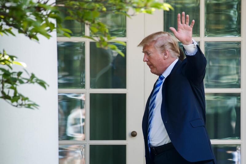 epa06728894 US President Donald J. Trump waves as he walks to the Oval Office after delivering remarks on lowering drug prices during an event in the Rose Garden of the White House in Washington, DC, USA, 11 May 2018. President Trump and Secretary of Health and Human Services Alex Azar announced the administration's plan to combat escalating prescription drug prices.  EPA/SHAWN THEW