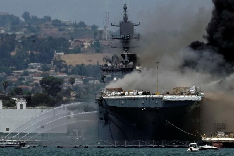 Firefighting boats spray water on to the US Navy ship 'USS Bonhomme Richard' as smoke rises from a fire on board at the naval base in San Diego, as seen from Coronado, California, US. Reuters