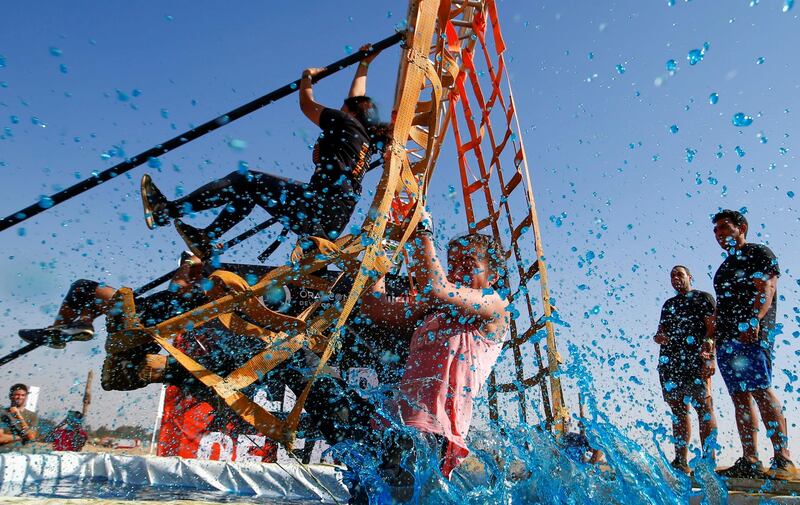 A competitor falls into the water during Egypt's Tough Mudder challenge, at the O West district, in Giza. Tough Mudder events have taken place in more than 25 countries around the world. Reuters