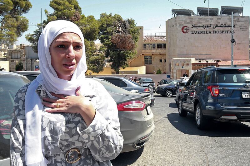 Israa Raed, whose 4-month-old baby girl Malak was removed from the rubble, outside the hospital where her child was receiving treatment. AFP