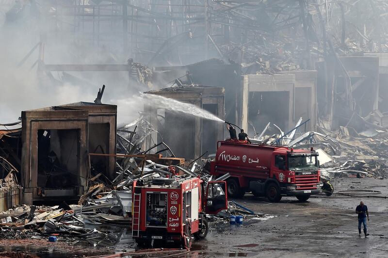 Firefighters extinguish a fire in a warehouse at the port of Beirut. EPA