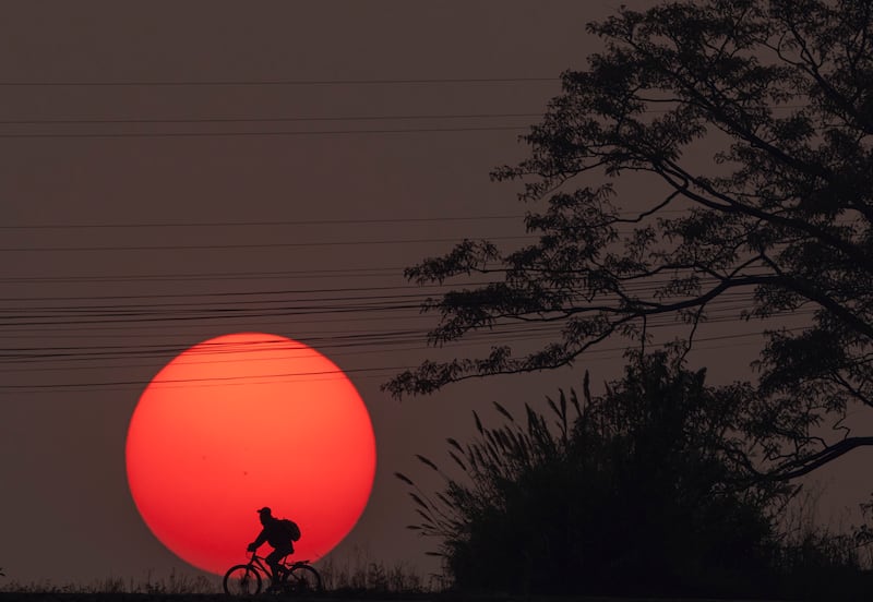 A cyclist rides along a road at sunset in Kathmandu, Nepal, on Friday April 26. EPA
