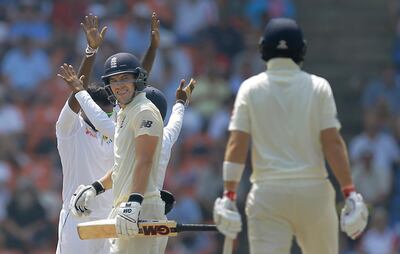 England's Rory Burns, left, looks at Joe Root after being dismissed by Sri Lanka's for scoring a half century during the third day's play of the second test cricket match between Sri Lanka and England in Pallekele, Sri Lanka, Friday, Nov. 16, 2018. (AP Photo/Eranga Jayawardena)