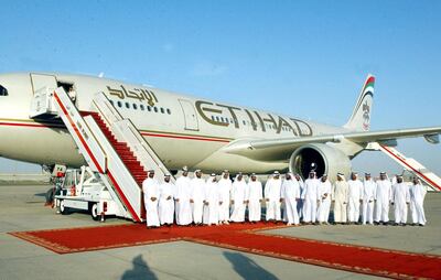 Emirati officials pose in front of the new carrier "Etihad" or "Unity" which was on show in the capital Abu Dhabi 03 November 2003. A day after the inaugural flight of Air Arabia, a no frills airline launched in the United Arab Emirates, the capital Abu Dhabi announced it would be setting up Etihad as a new carrier. Etihad, which is yet to be formally launched, is backed by the government of Abu Dhabi and has a paid up capital of 500 million dirhams (136 million dollars), reported today's Gulf News. Etihad, meaning unity, which has two leased Airbus A330-200 aircraft, will make its inaugural flight on November 5, flying from Abu Dhabi to the UAE desert city of Al Ain. AFP PHOTO/WAM (Photo by WAM / AFP)