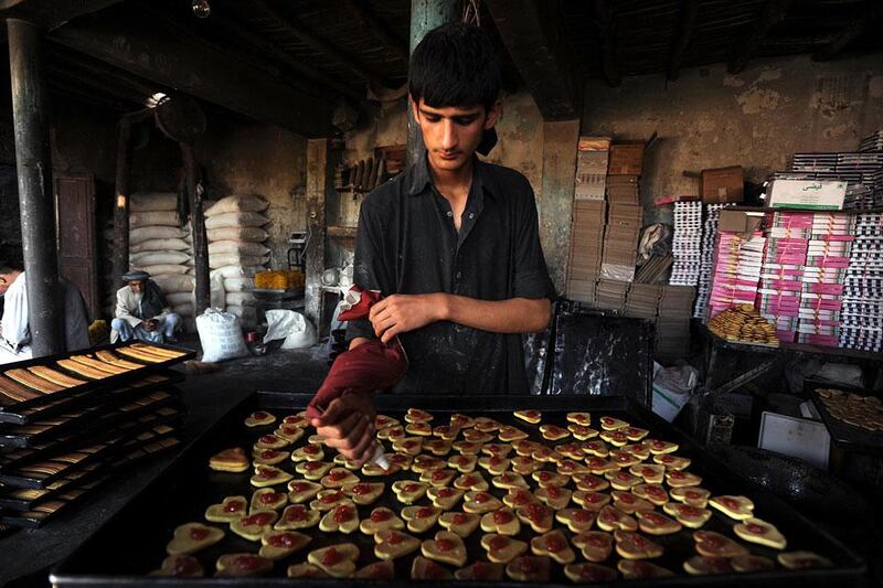 An Afghan man makes traditional cookies in Herat as Eid Al Fitr approaches. Aref Karimi / AFP Photo