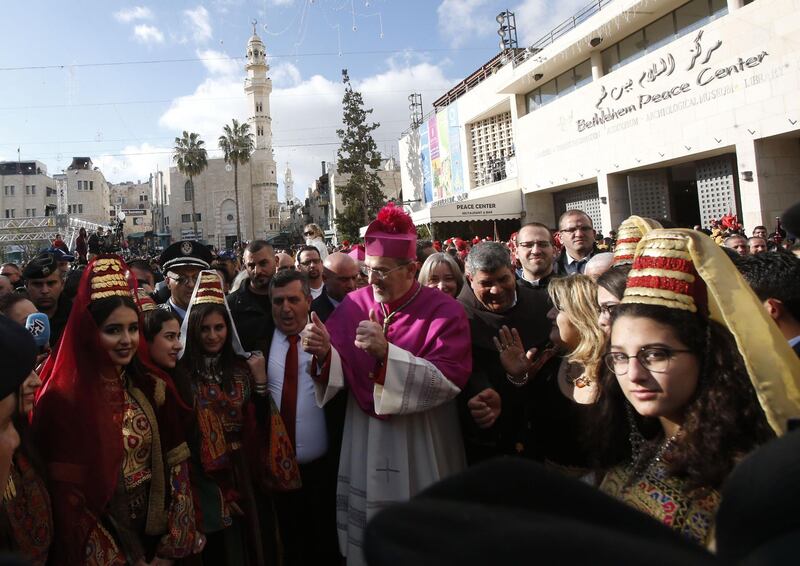 Latin Patriarch of Jerusalem Pierbattista Pizzaballa is greeted by a crowd as he arrives in the West Bank city of Bethlehem, on December 24, 2018. / AFP / HAZEM BADER
