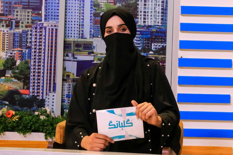 Shgofe, an Afghan newscaster, presents a programme on private channel 1TV in Kabul. Female TV presenters and reporters in Afghanistan continue to appear with their faces covered to comply with a mandate issued by the Taliban. EPA