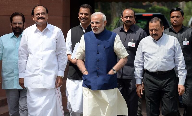 Indian prime minister Narendra Modi arrives at parliament with Ministers of Parliamentary Affairs, Mukhtar Abbas Naqvi (L), Venkaiah Naidu (2L), Rajiv Pratap Rudy (3L) and Jitender Singh (2R) in New Delhi on April 20. AFP Photo

