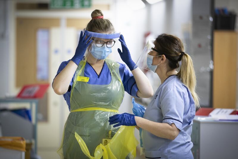 UK health workers put on personal protective equipment. British Prime Minister Boris Johnson hopes to avoid further Covid-19 lockdowns this winter. PA