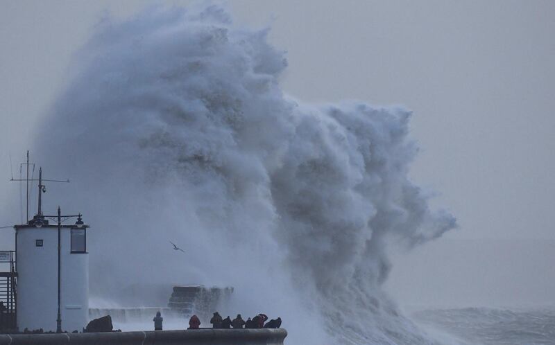 Large waves and high winds associated with Storm Eleanor crash against the lighthouse and seawall at Porthcawl in South Wales. Toby Melville / Reuters