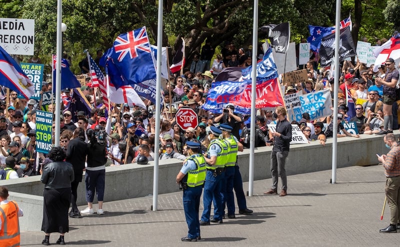 Police watch as Freedom and Rights Coalition protesters gather at Parliament, in Wellington, New Zealand, on Tuesday, November 9, 2021. NZ Herald via AP