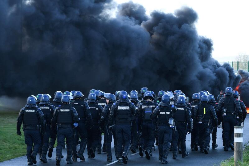 French gendarmes arrive for evacuation as prison guards block the entrance to the penitentiary center of Alencon, in Conde-sur-Sarthe, northwestern France, two days after a prison inmate seriously wounded two guards in a knife attack before being detained in a police raid.   The prison of Alencon / Conde-sur-Sarthe, where two guards were seriously stabbed on March 5 by a radicalized detainee, was blocked again on March 7 by about a hundred prison guards.  AFP