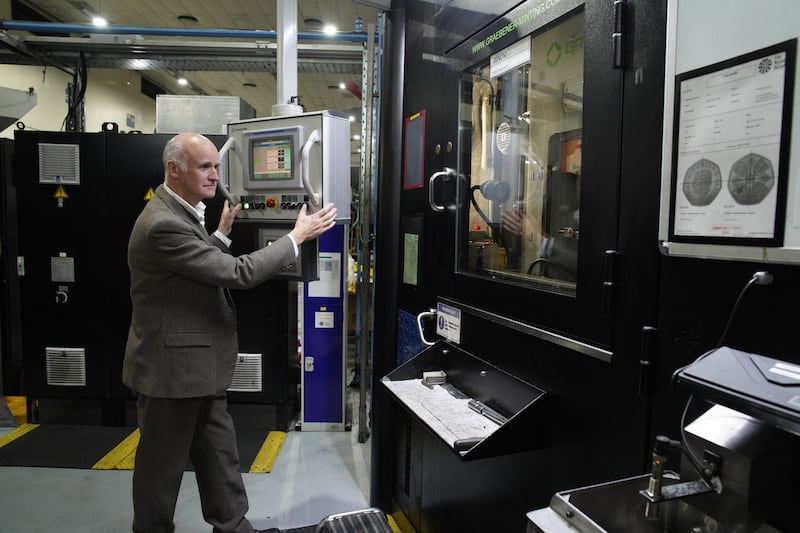 Artist Martin Jennings, who created the king's likeness, prepares the first coins.