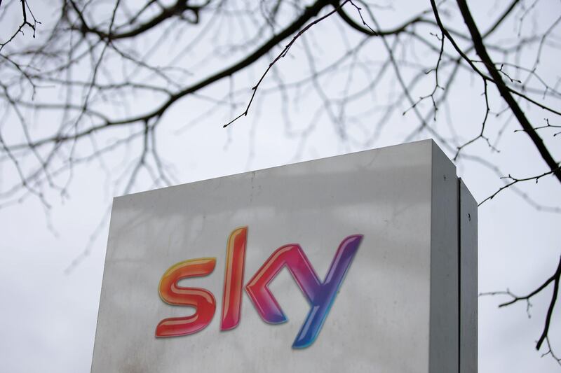 (FILES) In this file photo taken on March 17, 2017 a Sky logo is pictured on a sign next to the entrance to pay-TV giant Sky Plc's headquarters in Isleworth, west London. Rupert Murdoch's 21st Century Fox on Wednesday, July 11, 2018, revealed it had increased a takeover offer for pan-European TV group Sky, valuing the group at ��24.5 billion ($32.5 billion, 27.7 billion euros) and trumping Comcast's rival offer. / AFP / Daniel LEAL-OLIVAS
