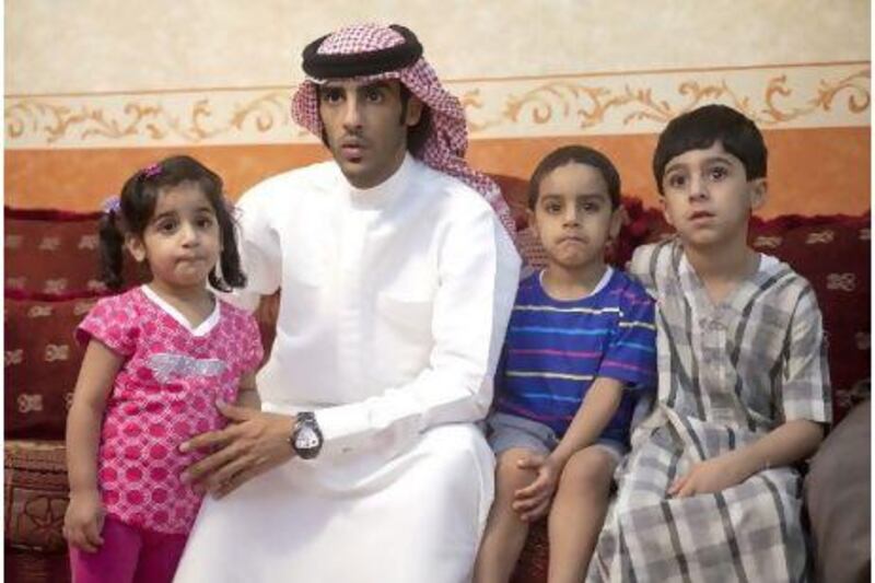 Ahmed al Dhamani with his daughter Fajer, son Magad and nephew Fahad in the family home.