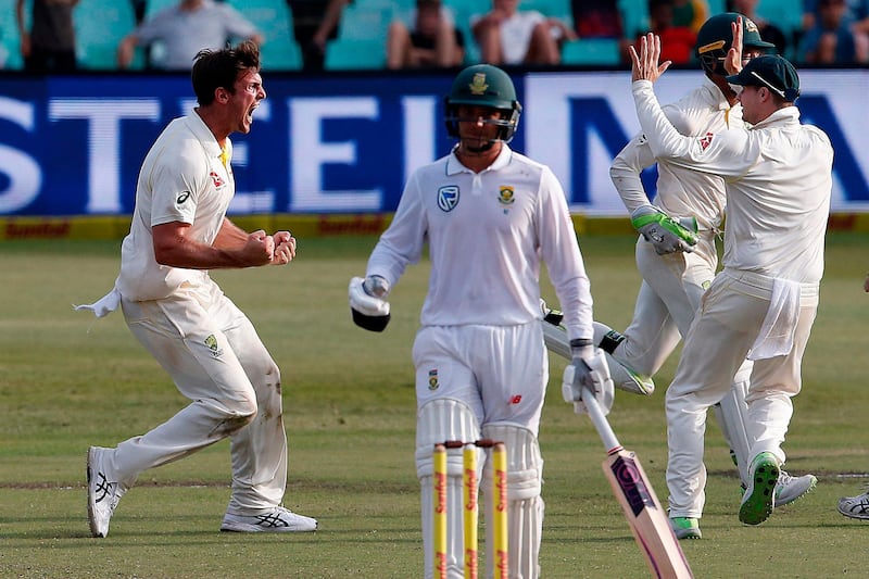 Australia's bowler Mitchell Marsh (L) celebrates taking the wicket of South Africa's batsman Aiden Markram during the fourth day of the first Test cricket match between South Africa and Australia at The Kingsmead Stadium in Durban on March 4, 2018. / AFP PHOTO / MARCO LONGARI