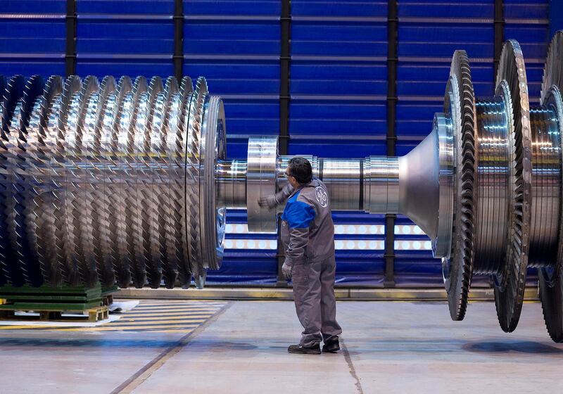 A General Electric Co. employee examines a component for gas turbine at the company's factory in Belfort, France, on Tuesday, Dec. 14, 2010. General Electric Co. said sales may increase as much as 5 percent next year as its industrial divisions return to growth and profit climbs. Photographer: Fabrice Dimier/Bloomberg
