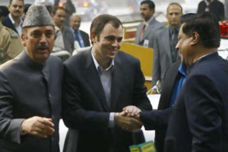 National Conference chief Omar Abdullah (C) is congratulated by senior Congress leader Prithviraj Chavan (R) as former Chief Minister of Jammu and Kashmir Ghulam Nabi Azad (L) looks on in New Delhi on December 30, 2008. A 38-year-old Muslim politician is all set to be the new chief minister of revolt-hit Indian-administered Kashmir, the third from his family to get the top job. Omar Abdullah, the leader of pro-India National Conference (NC), will head the new government in Kashmir in alliance with Congress, which leads a coalition government in the center. AFP PHOTO/ Manpreet ROMANA *** Local Caption ***  989282-01-08.jpg
