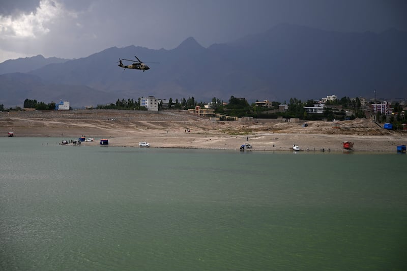 An Afghan National Army helicopter flies over the Qargha Lake on the outskirts of Kabul on July 16, 2021.
