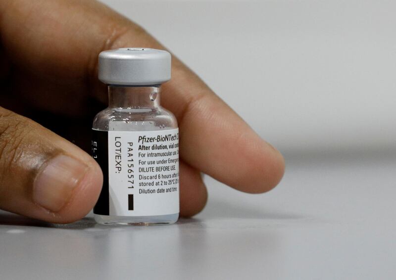 FILE PHOTO: A medical worker prepares to dilute a vial of Pfizer-BioNTech vaccine at a coronavirus disease (COVID-19) vaccination center in Singapore March 8, 2021. REUTERS/Edgar Su/File Photo